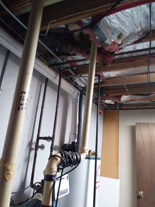 Professionally cord wrapped water outlet that probably leads to the rest of the plumbing... somewhere